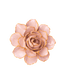 A single artificial flower bloom with pale blush pink petals and metallic gold edging, photographed from above on a plain white background.