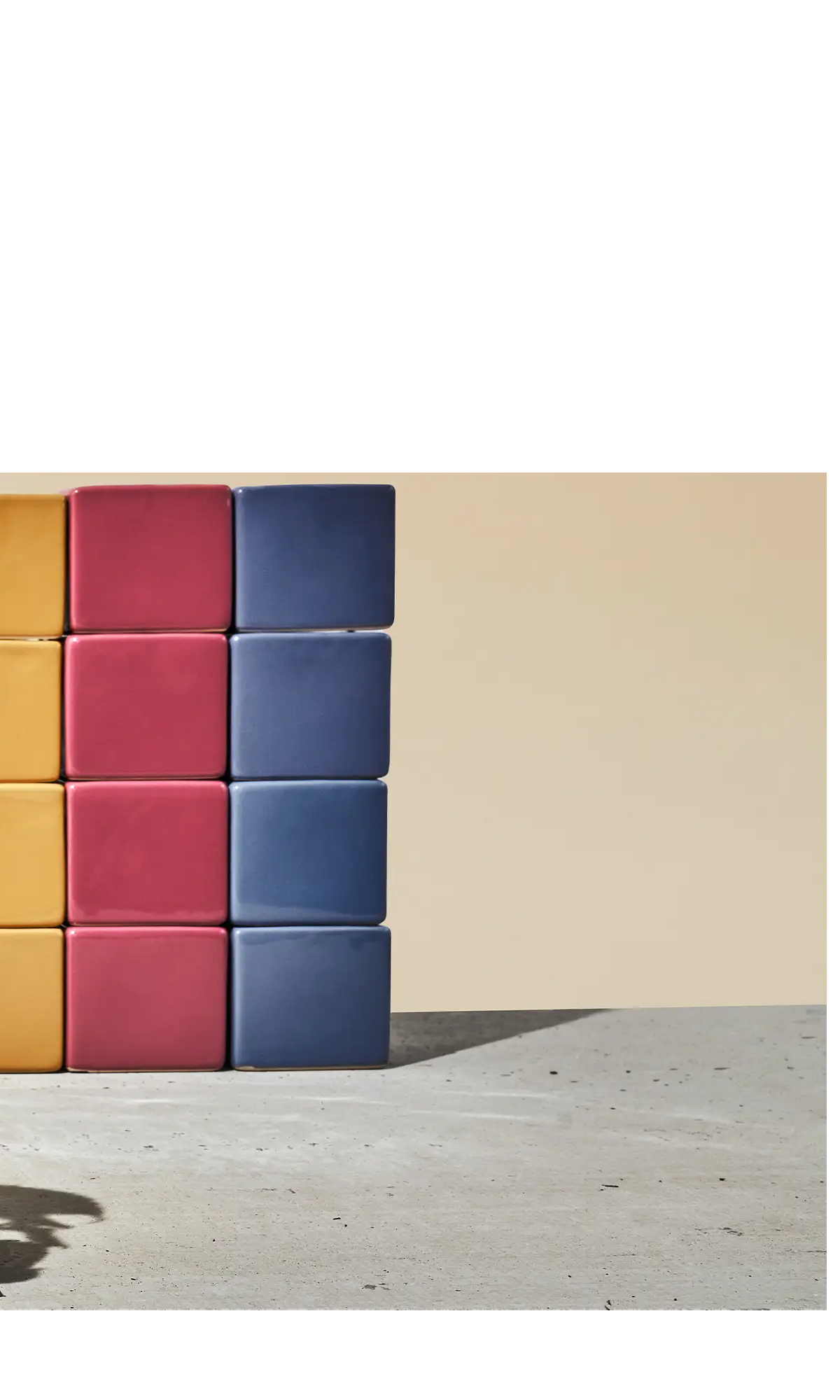 Chive Cube glazed ceramic mini square planters stacked in goldenrod, pink, and blue.