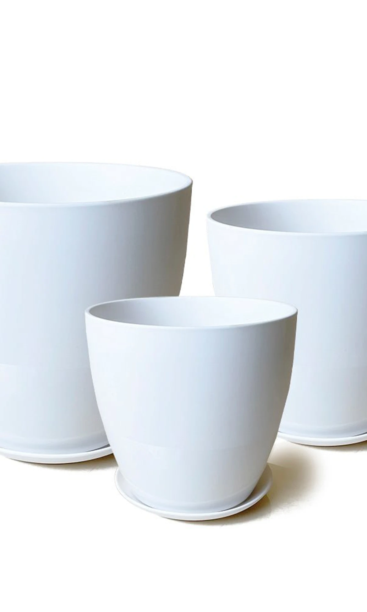 Three Chive Dyad white porcelain pots with drainage and detachable saucers in large, medium, and small.