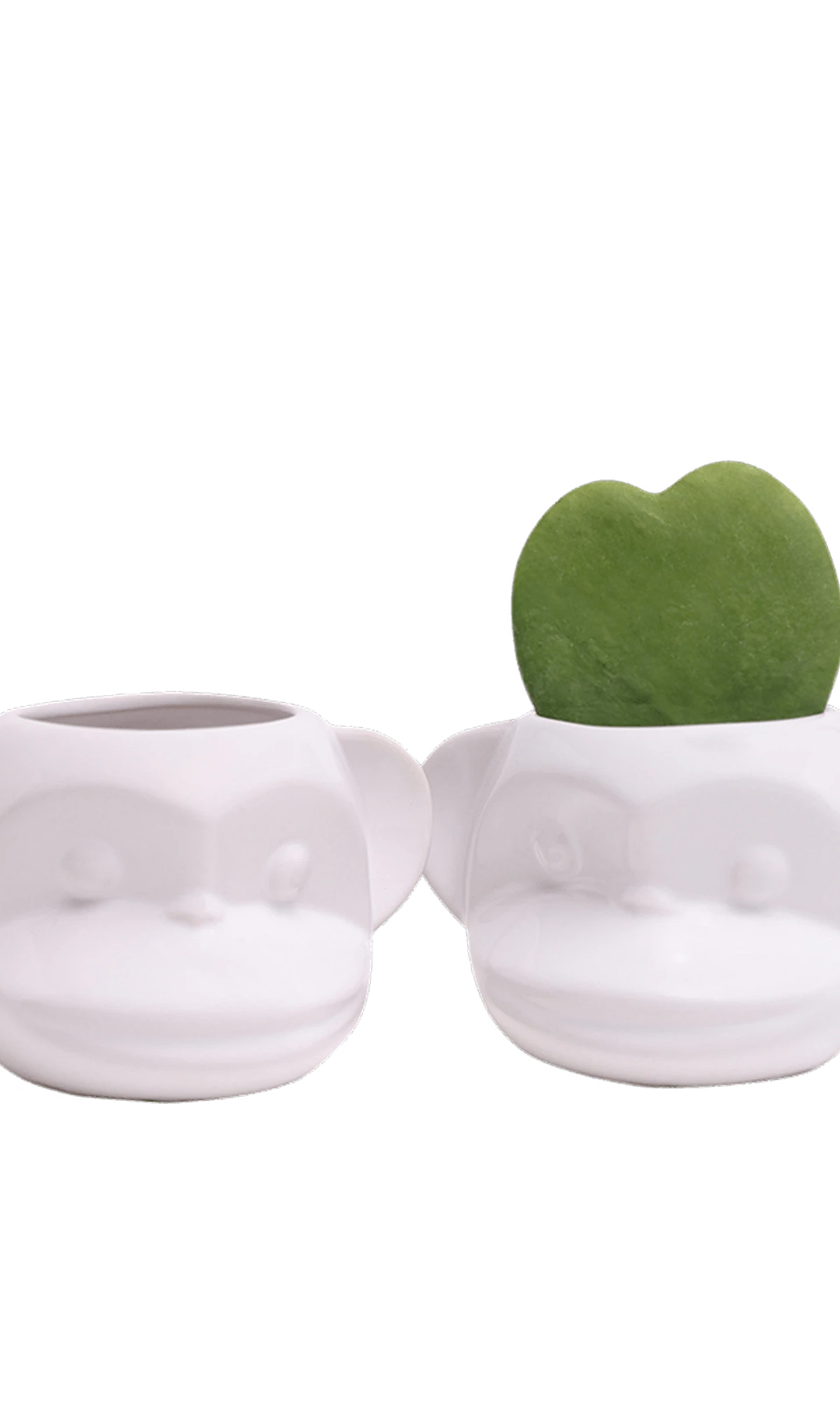 Two Chive Funky Monkey White glazed ceramic monkey shaped planters styled with a small plant.