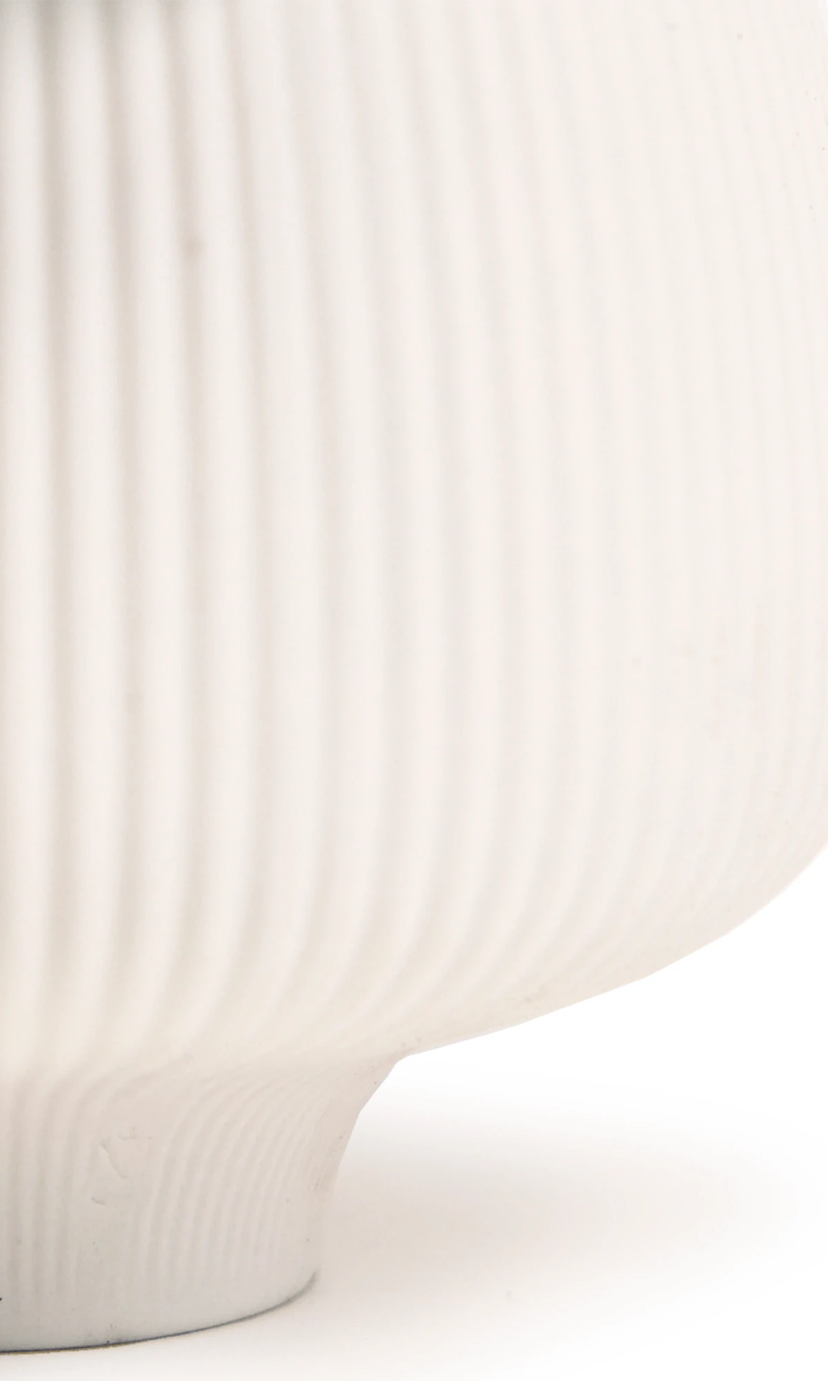 Close-up of the matte and ribbed finish on a Chive Lilo white porcelain large plant pot.
