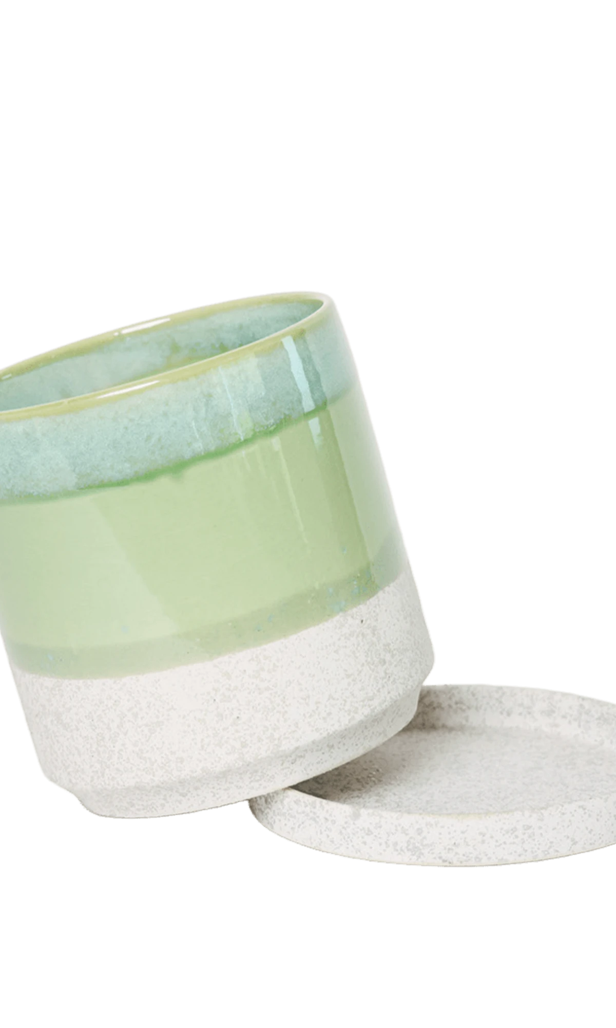 Chive Minute small green cement ceramic pot with drainage tilted to show the detachable saucer.