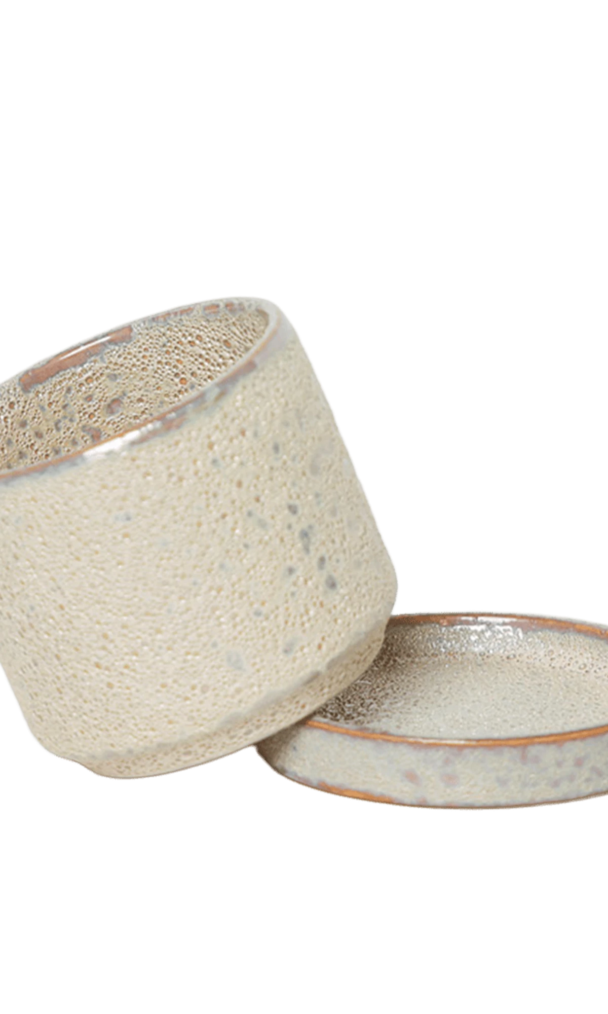 Chive Minute small ivory speckles ceramic pot with drainage tilted to show the detachable saucer.