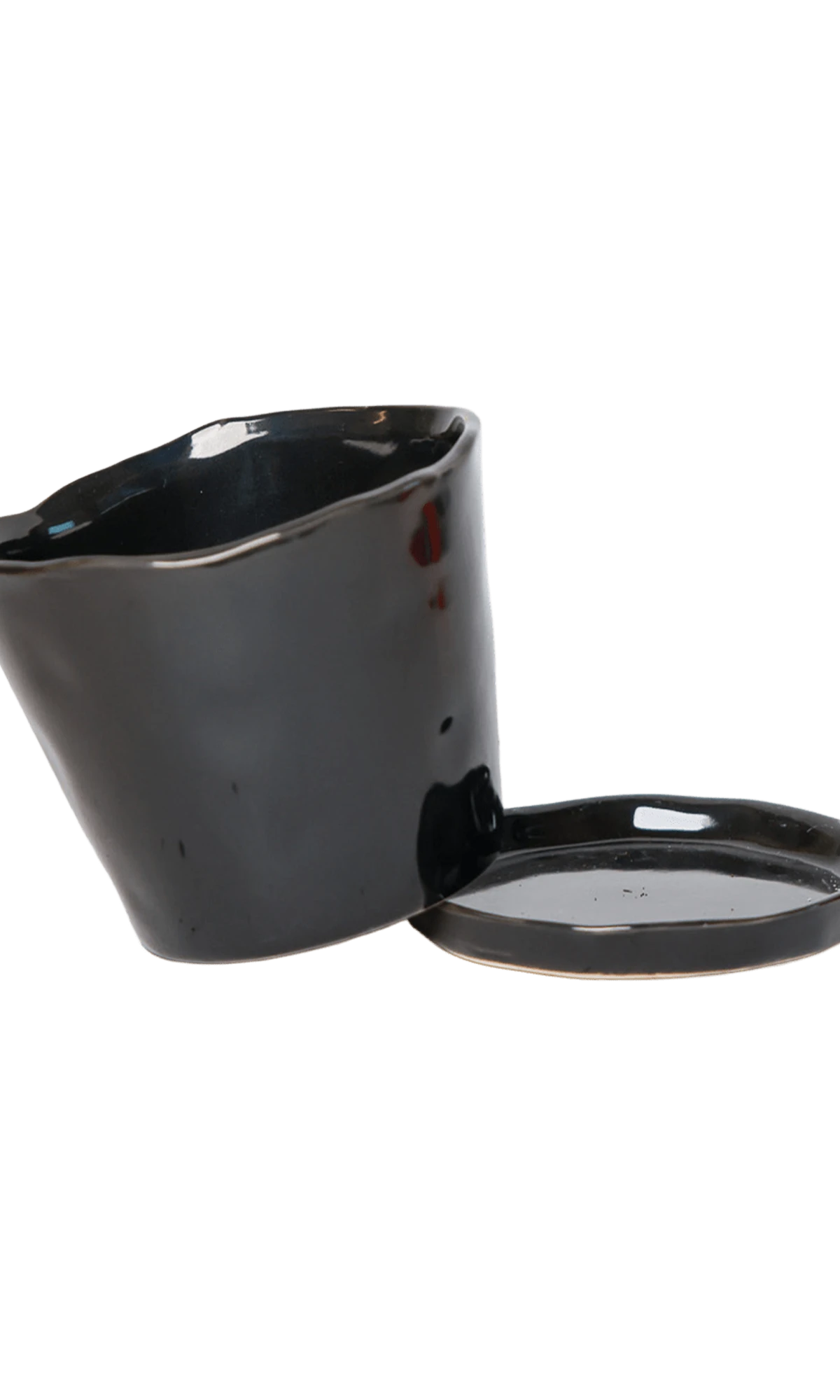 Chive Tika black glazed ceramic small plant pot with drainage tilted to show the detachable saucer.