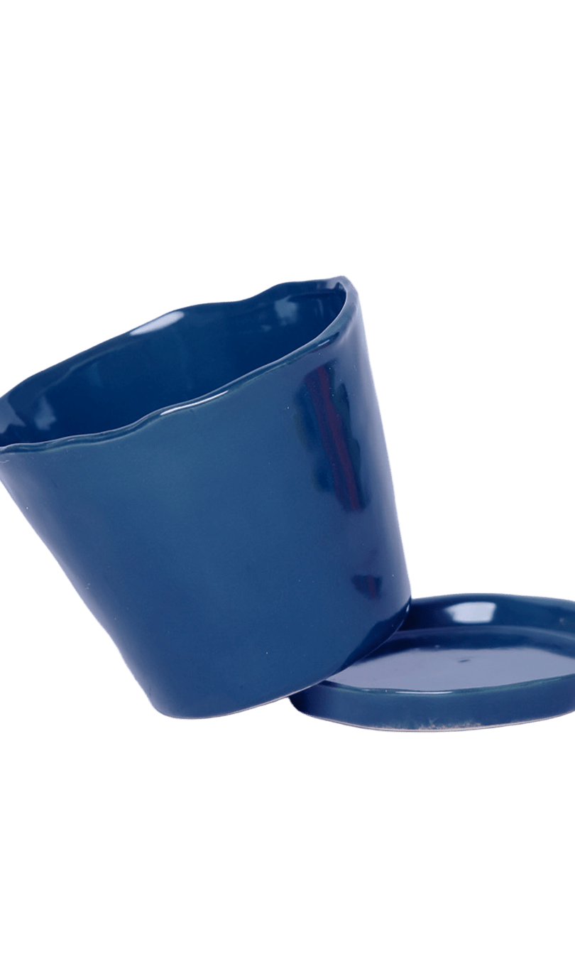 Close-up of the detachable saucer and drainage hole on a Chive Tika cobalt ceramic pot.