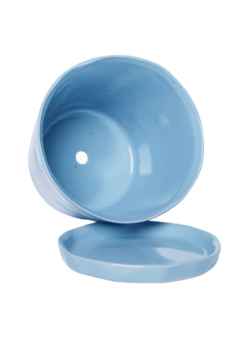 Close-up of the detachable saucer and drainage hole on a Chive Tika periwinkle ceramic large pot.