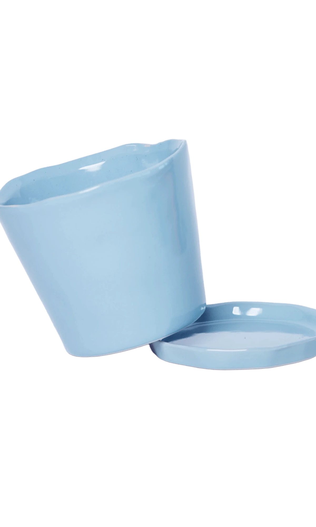 Close-up of the detachable saucer and drainage hole on a Chive Tika periwinkle ceramic medium pot.