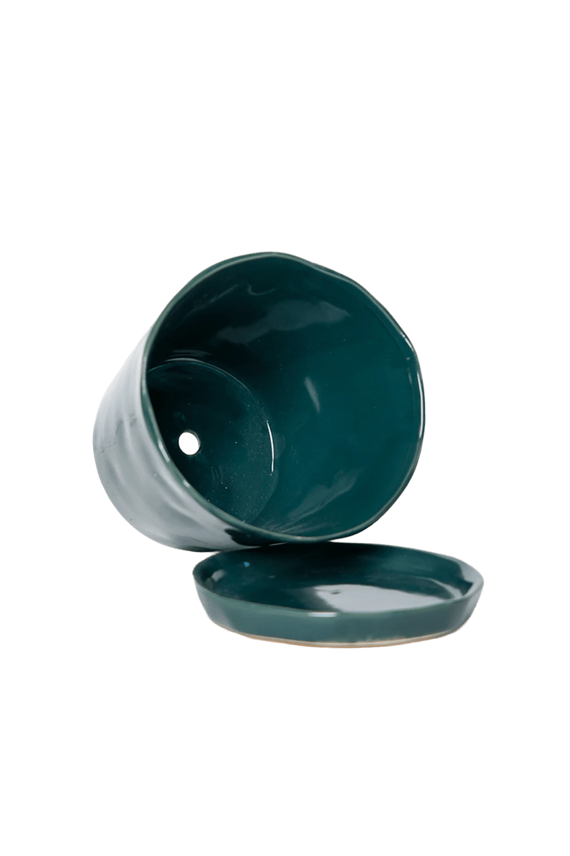 Close-up of the detachable saucer and drainage hole on a Chive Tika spruce ceramic large pot.