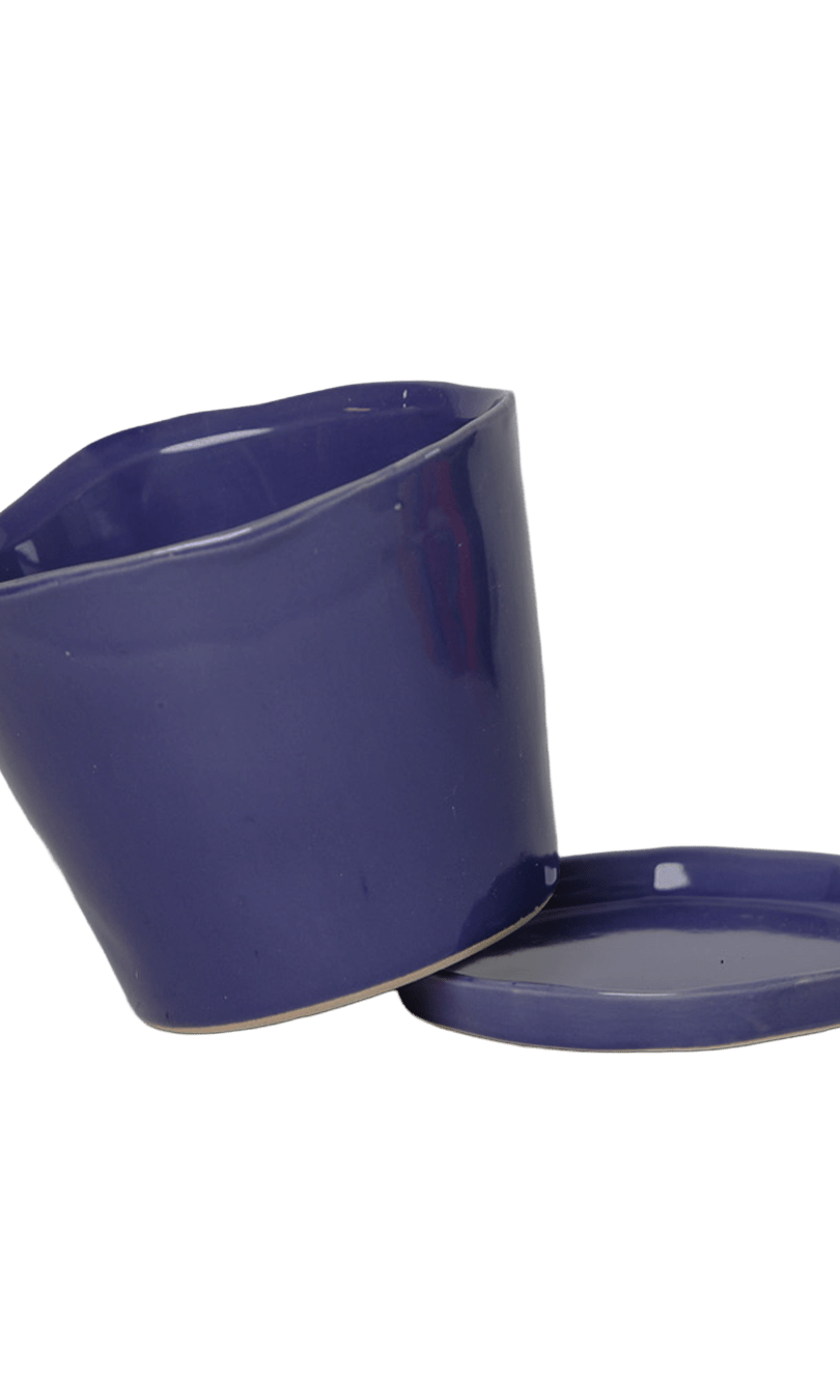 Chive Tika ultra violet ceramic small plant pot with drainage tilted to show detachable saucer.
