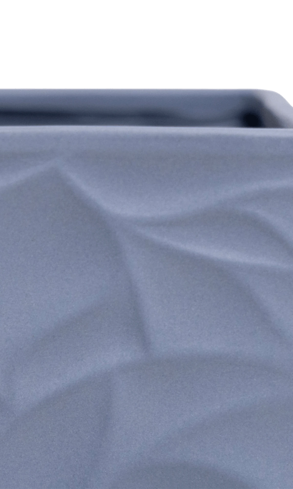 Close-up of the Chive Virago D medium blue grey porcelain pot showing the color and geometric texture.