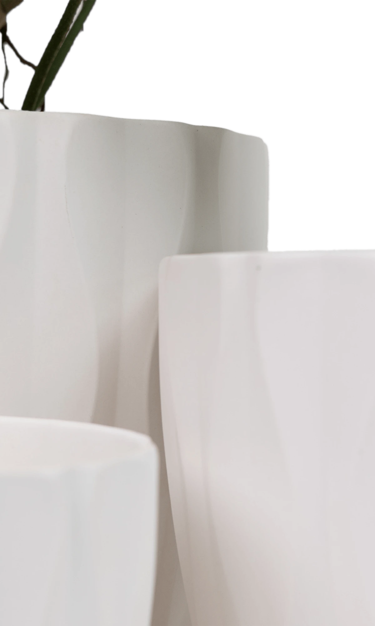 Close-up of three Chive Virago E white porcelain pots in large, medium, and small showing the vertical waves texture.