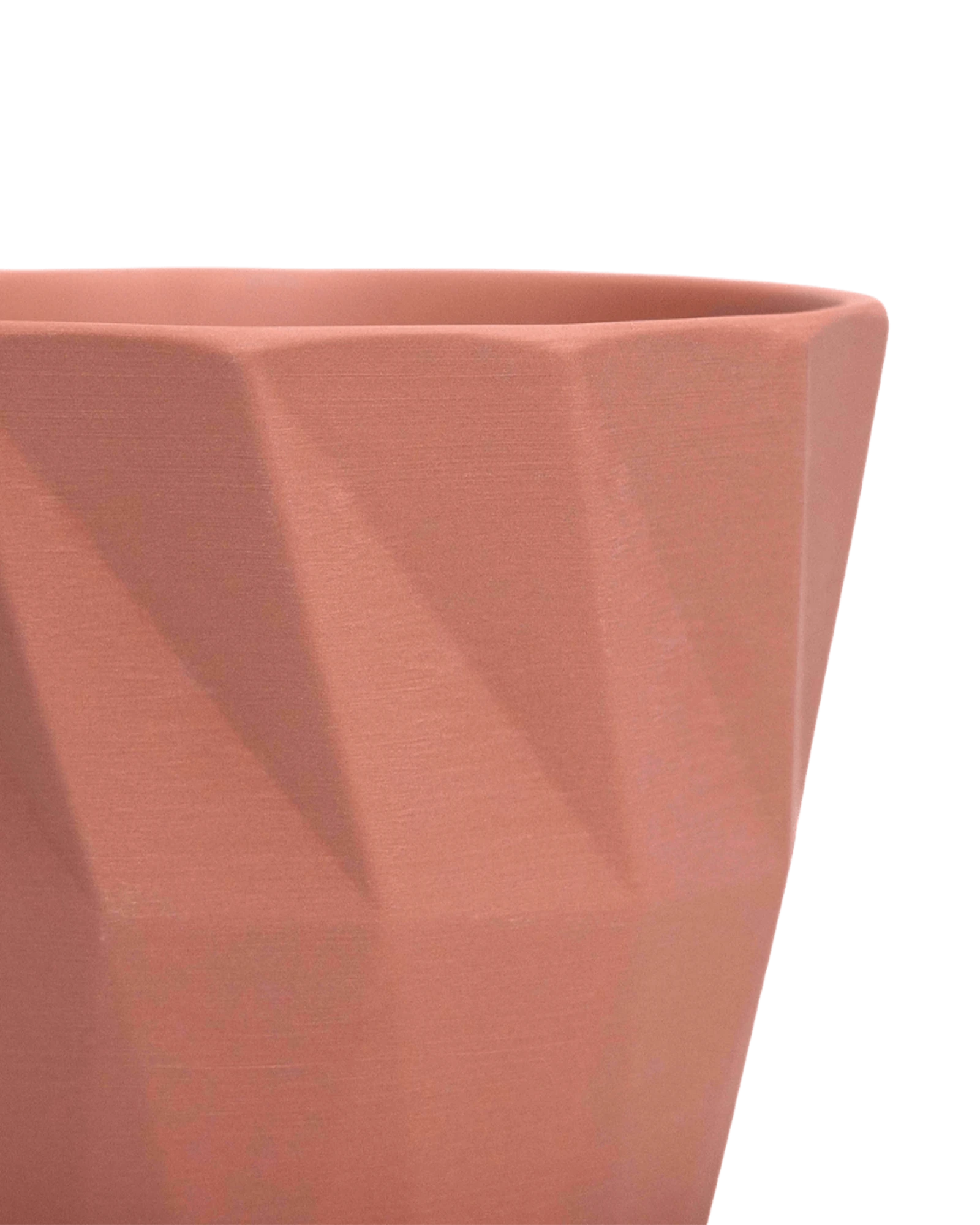 Close-up of the Chive Virago G medium clay terracotta porcelain pot showing the color and geometric texture.