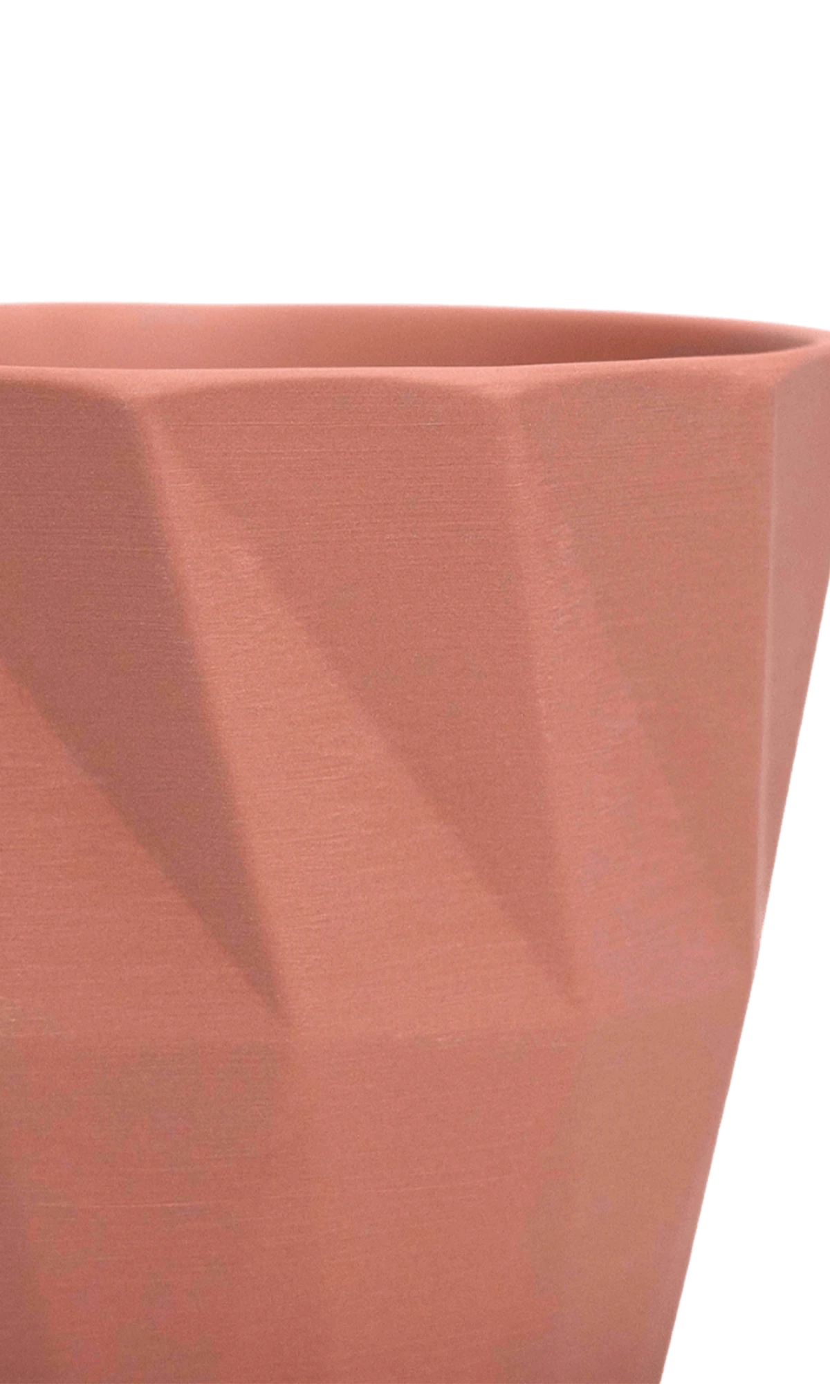 Close-up of the Chive Virago G small clay terracotta porcelain pot showing the color and geometric texture.