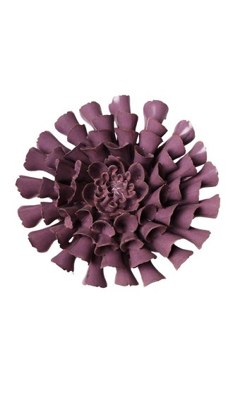 A single sculptural flower-shaped product in a muted plum-purple color, photographed from above on a plain white background.