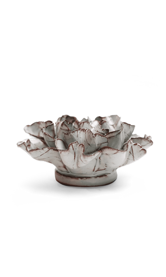 A sculptural ceramic lotus flower bowl with a textured, weathered finish in off-white and gray with subtle reddish-brown accents along the petal edges, set against a plain white background.
