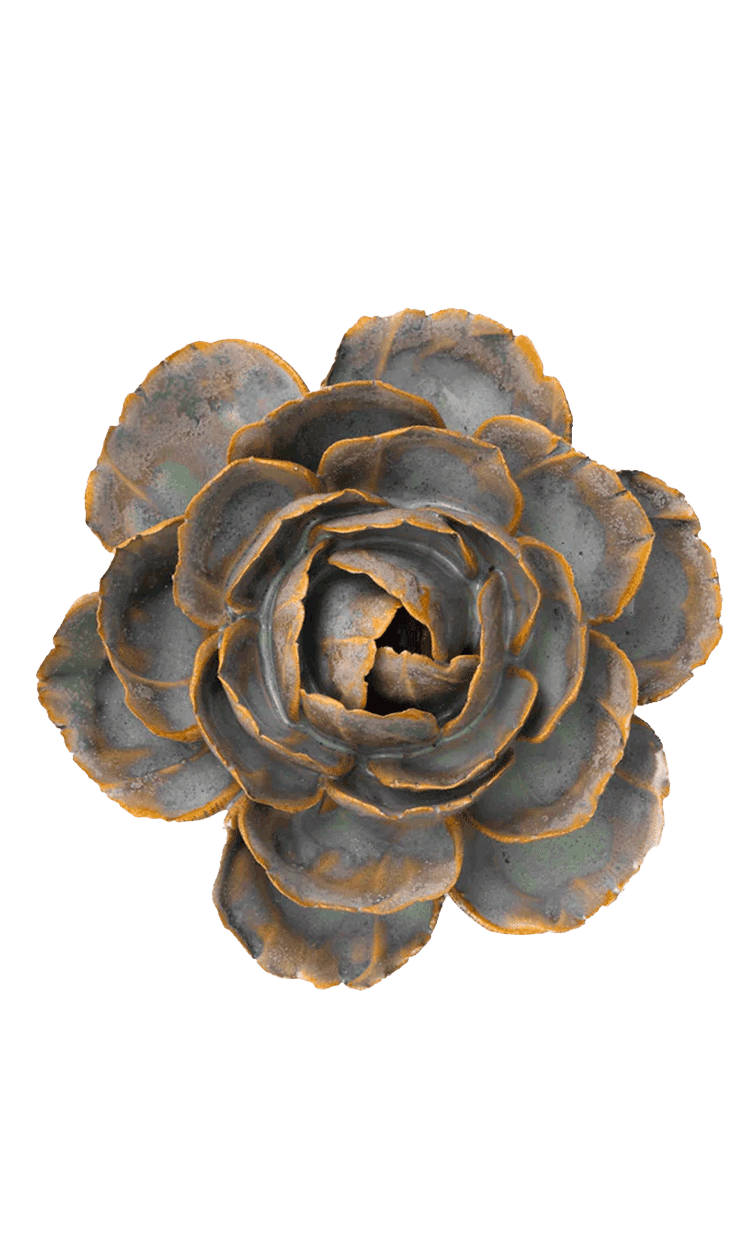 A decorative faux succulent flower with layered gray-blue petals and rusty orange edges, isolated on a solid white background.