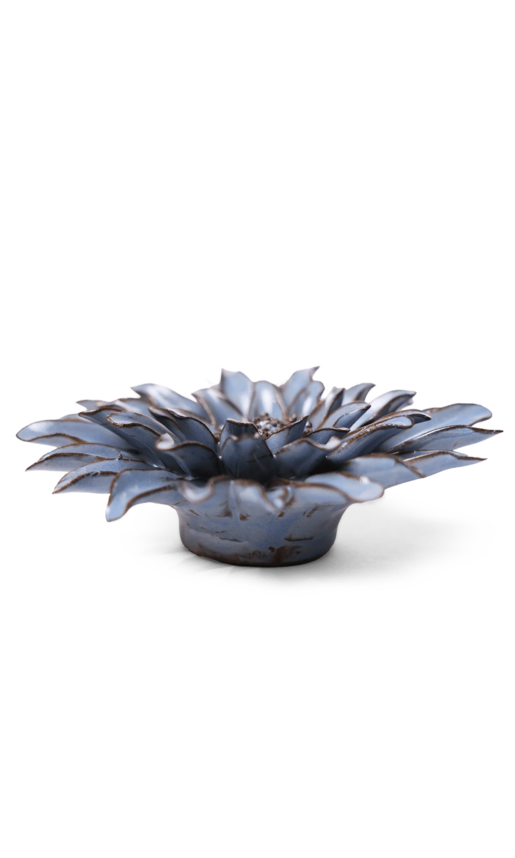 A small sculptural flower-shaped dish or candle holder with layered petals, shown on a clean white background.