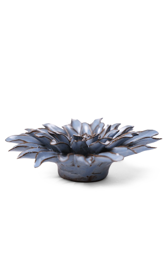 A small sculptural flower-shaped dish or candle holder with layered petals, shown on a clean white background.