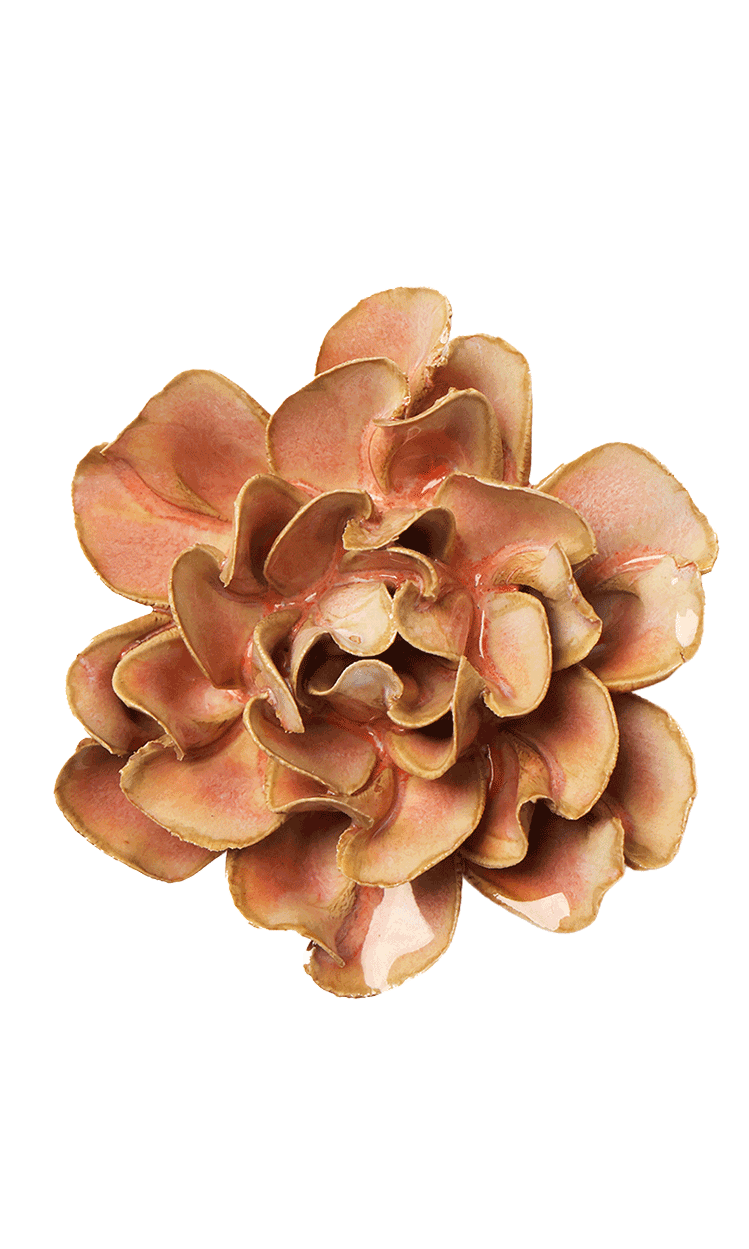A single artificial flower bloom with layered ruffled petals in warm peach, tan, and light brown tones, isolated on a plain white background.