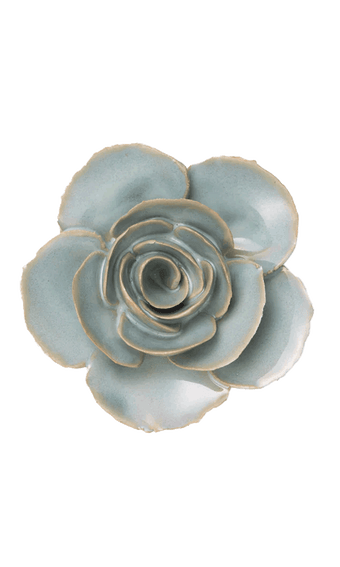 A ceramic succulent-style flower figurine with pale blue-green glazed petals and natural clay edges, photographed from directly above on a plain white background.