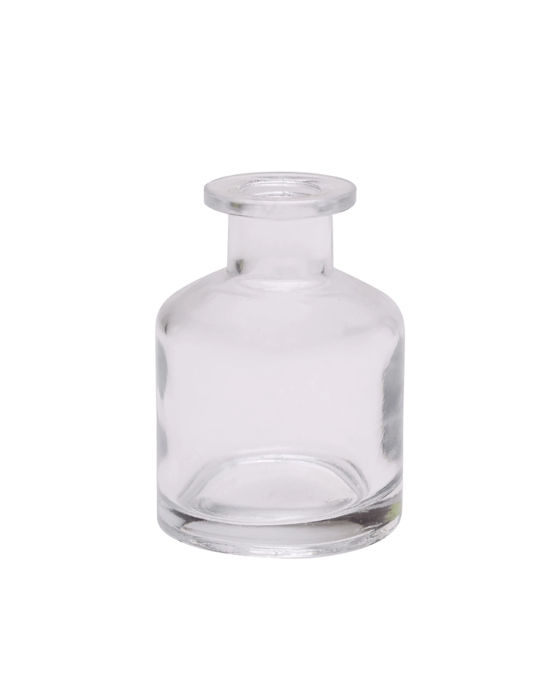 Chive Loft apothecary glass bud vase in clear glass with a tall cylindrical silhouette and wide lip.