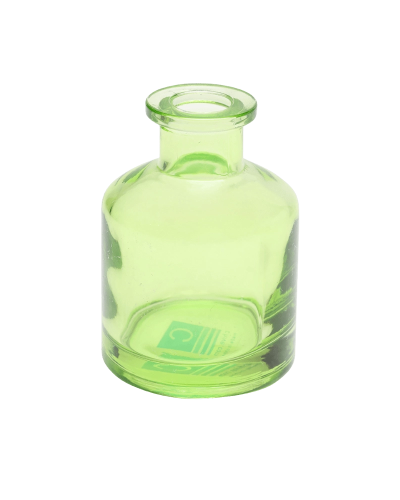 Chive Loft apothecary glass bud vase in green with a tall cylindrical silhouette and wide lip.