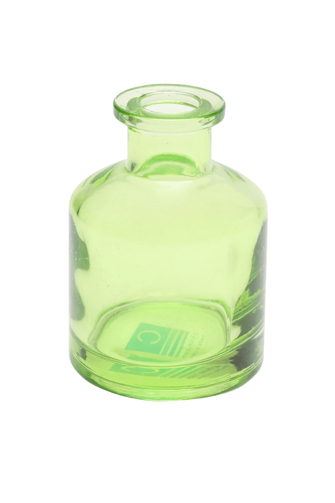 Chive Loft apothecary glass bud vase in green with a tall cylindrical silhouette and wide lip.