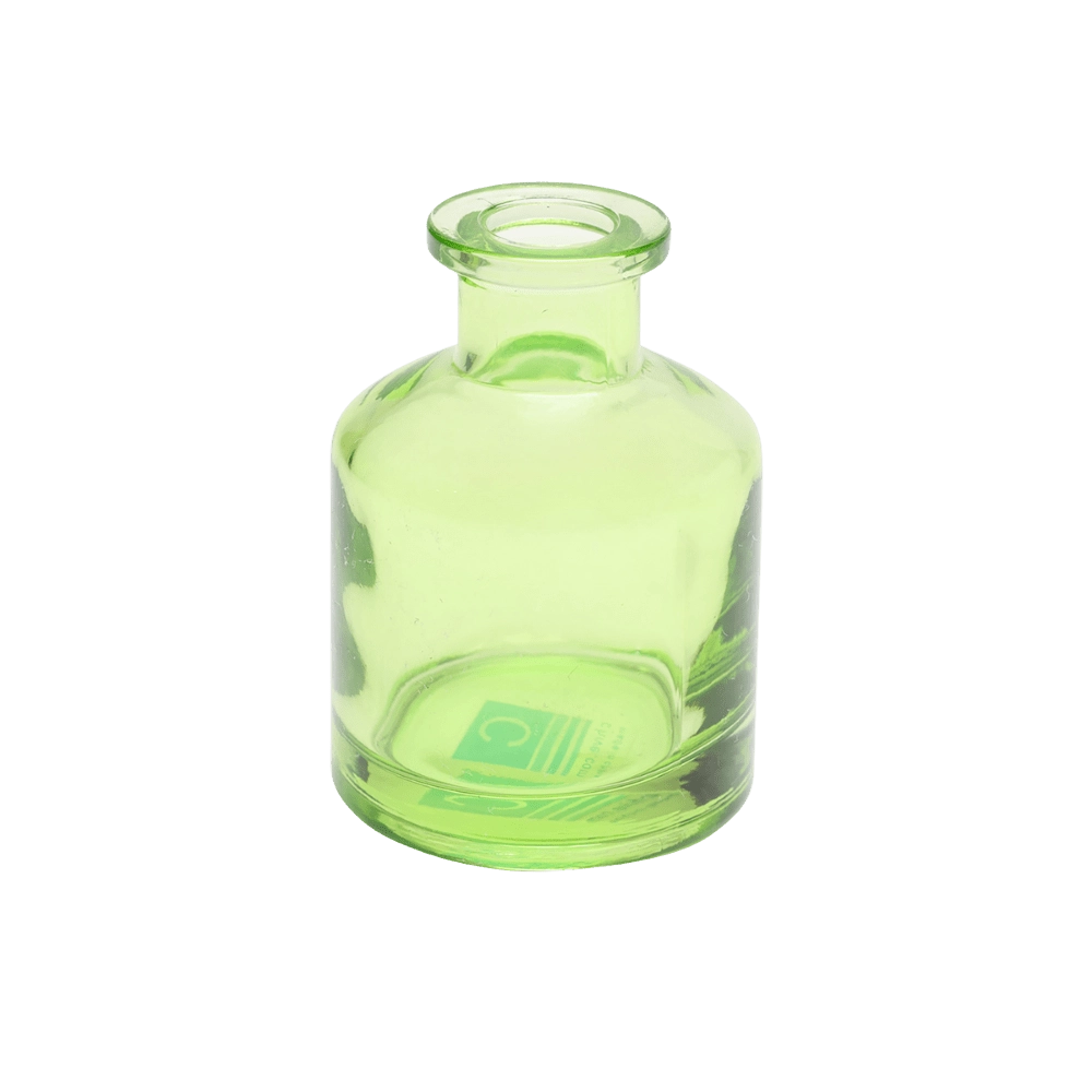 Chive Loft apothecary glass bud vase in green with a tall cylindrical silhouette and wide lip.