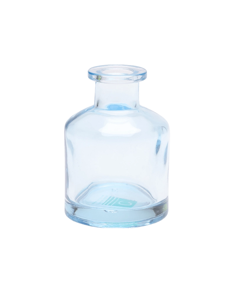 Chive Loft apothecary glass bud vase in light blue with a tall cylindrical silhouette and wide lip.