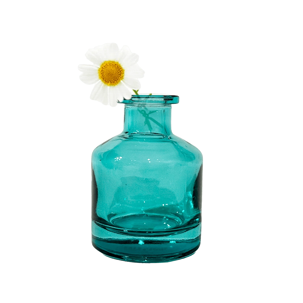 Chive Loft apothecary glass bud vase in teal styled with a single white daisy bloom.