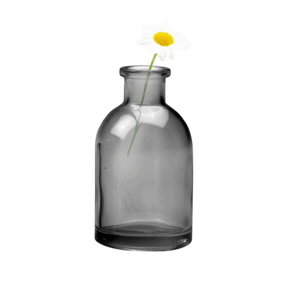 Chive Loft glass bud vase in smoke grey styled with a single white daisy bloom.