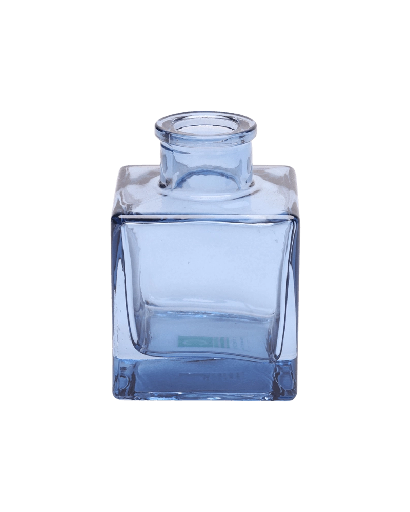 Chive Loft cube glass bud vase in medium blue with a raised collar neck and clean square silhouette.