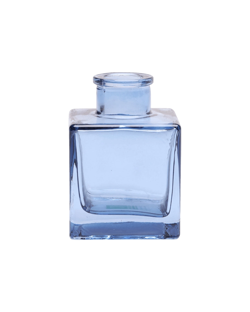 Chive Loft cube glass bud vase in medium blue, shown at an angle with a glossy faceted finish.