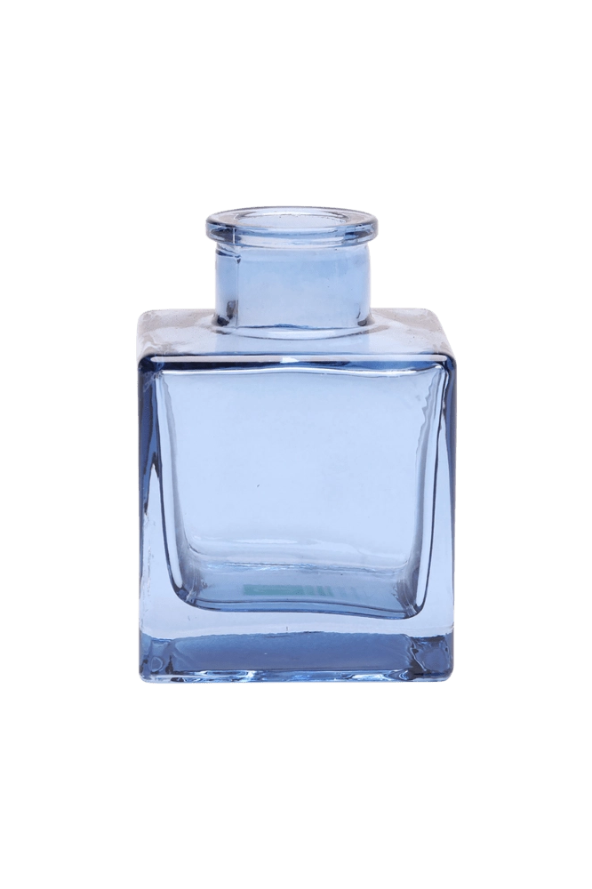 Chive Loft cube glass bud vase in medium blue, shown at an angle with a glossy faceted finish.