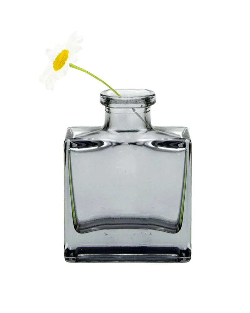 Chive Loft cube glass bud vase in smoke grey styled with a single white daisy bloom.