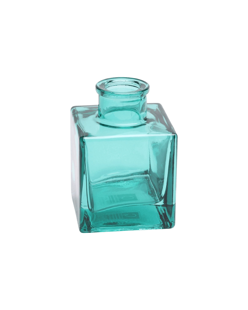 Chive Loft cube glass bud vase in teal, shown at an angle with a glossy faceted finish.