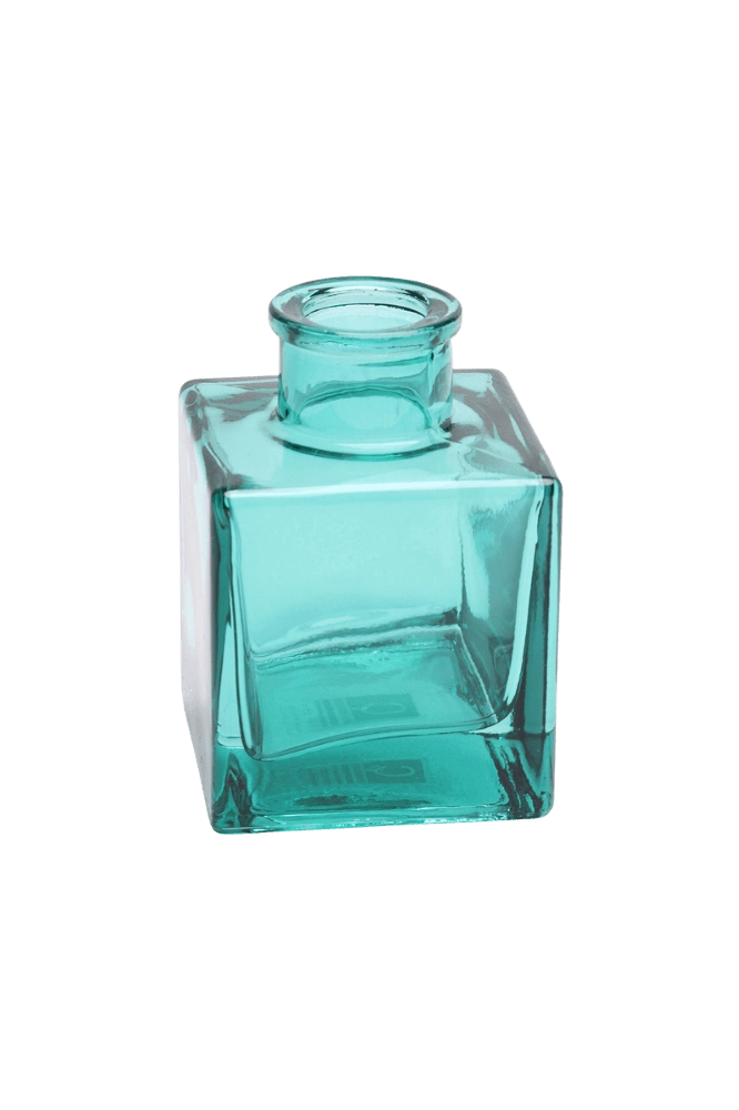 Chive Loft cube glass bud vase in teal, shown at an angle with a glossy faceted finish.
