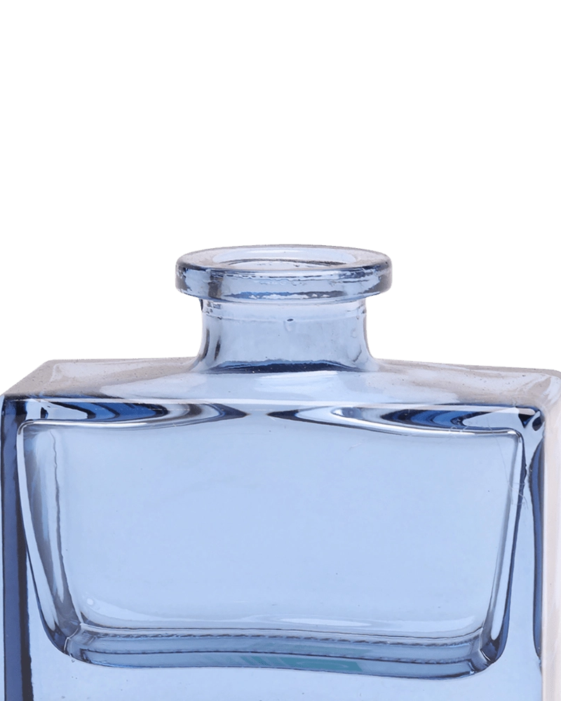 Chive Loft square glass bud vase in blue-grey, close-up on the narrow neck and thick glass base.