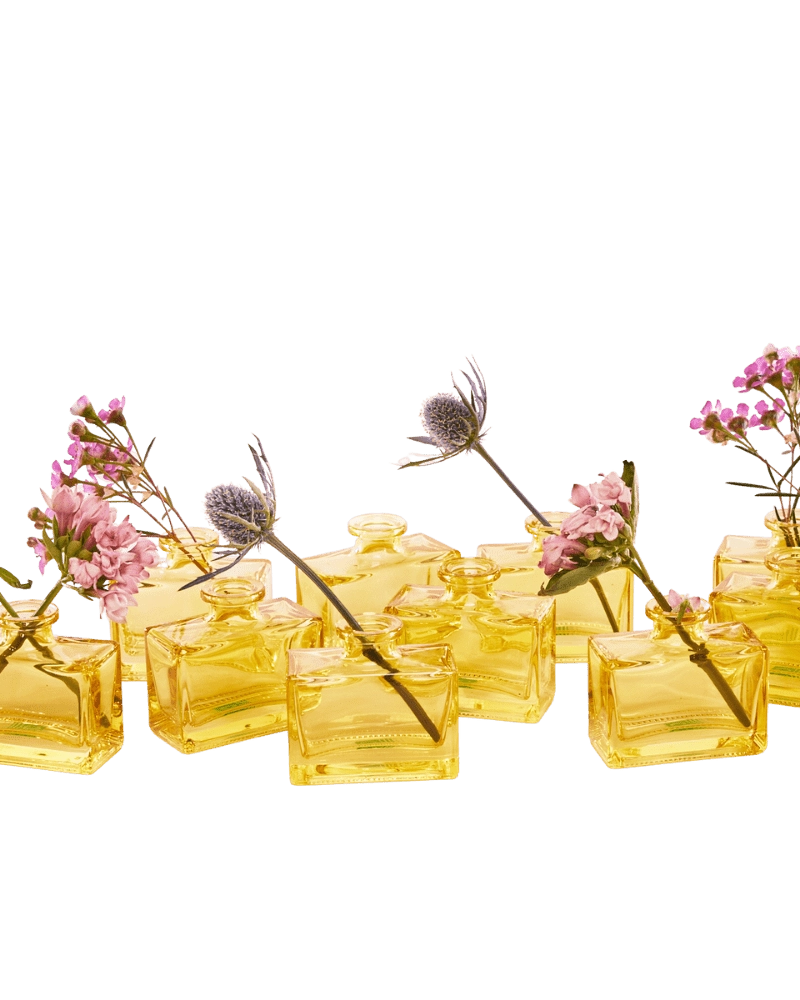 Chive Loft rectangle glass bud vases in yellow grouped together, styled with mixed pink florals.