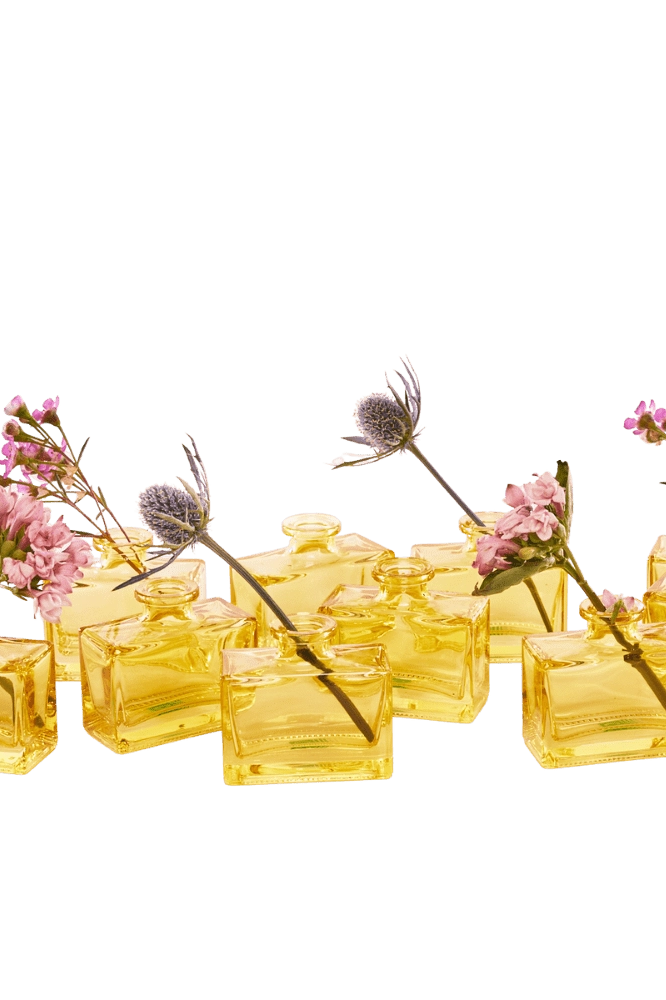 Chive Loft square glass bud vases in yellow grouped together, styled with mixed pink florals.