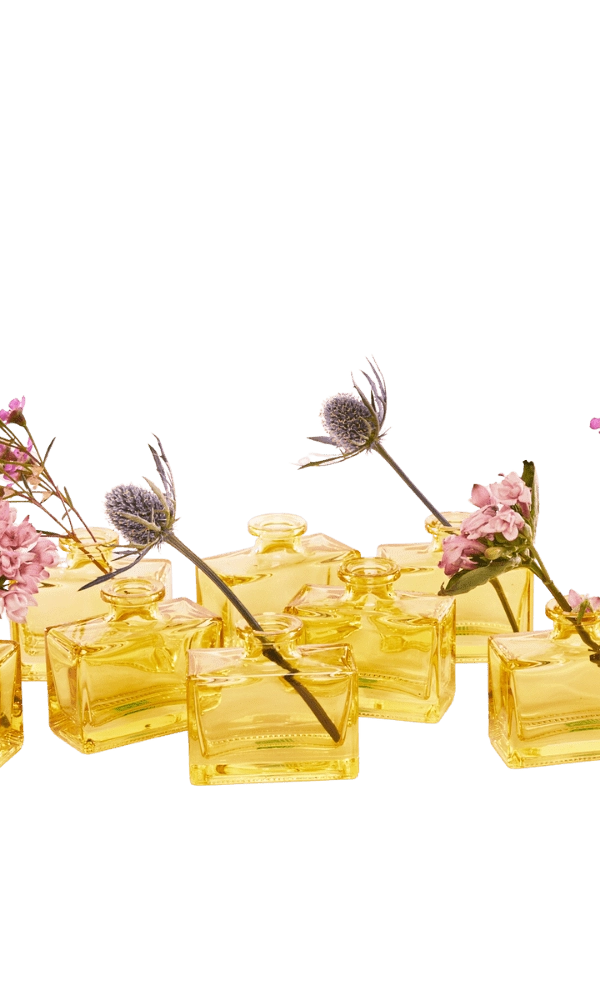 Chive Loft rectangle glass bud vases in yellow grouped together, styled with mixed pink florals.