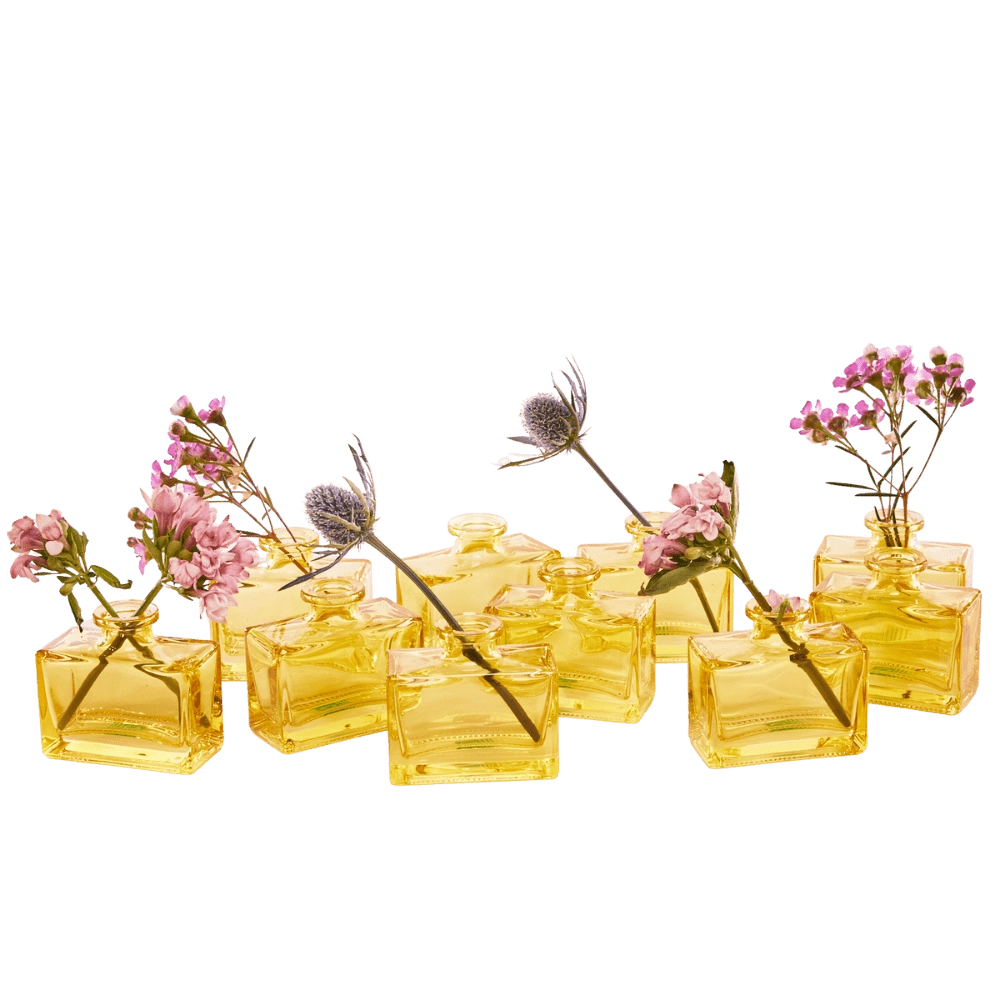 Chive Loft square glass bud vases in yellow grouped together, styled with mixed pink florals.