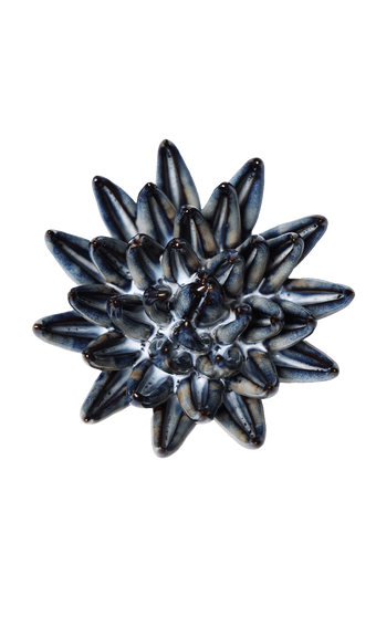 A single round button with a textured, starburst-like pattern of dark blue, black, and white stripes, shown on a plain white background.