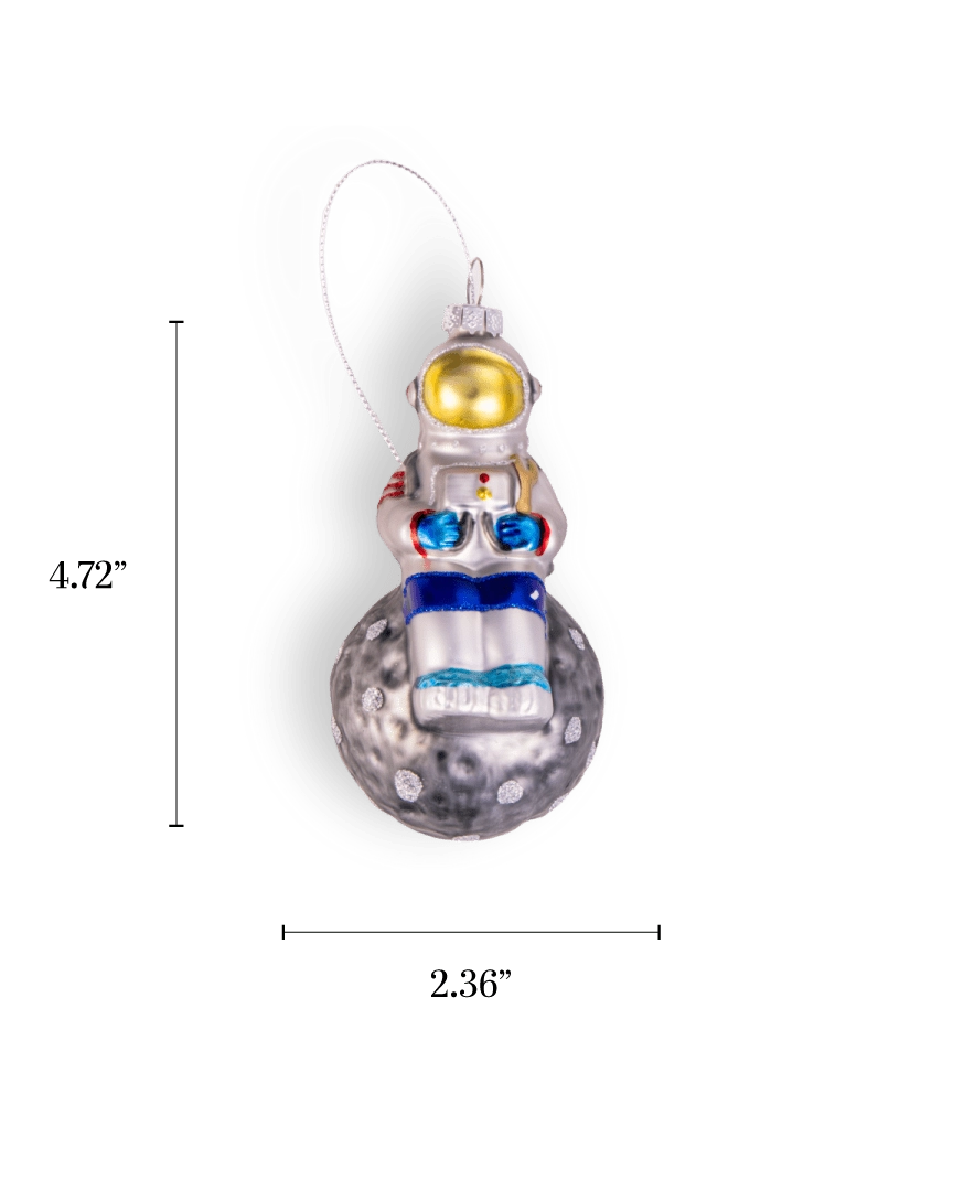 Chive glass astronaut ornament in silver perched atop a glittered moon.