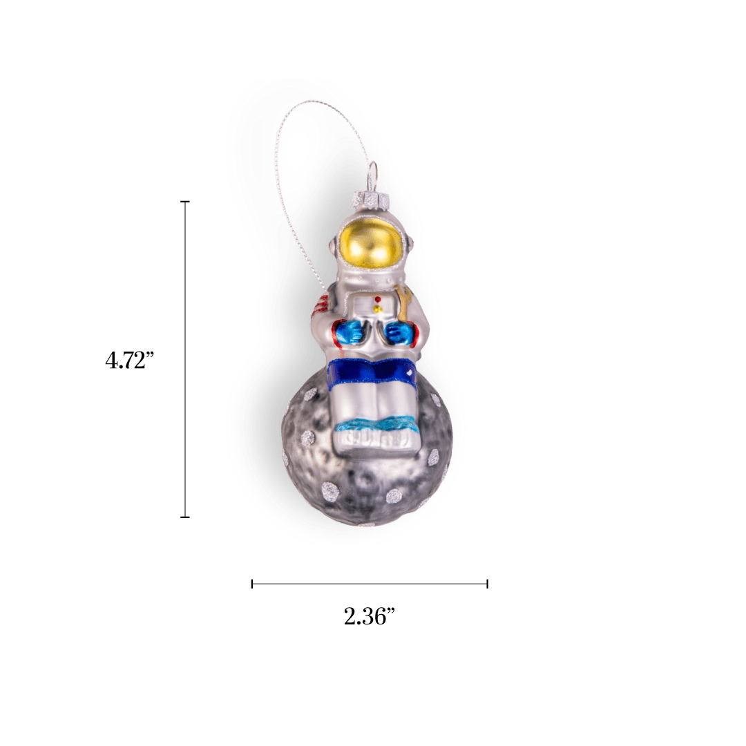 Chive glass astronaut ornament in silver perched atop a glittered moon.