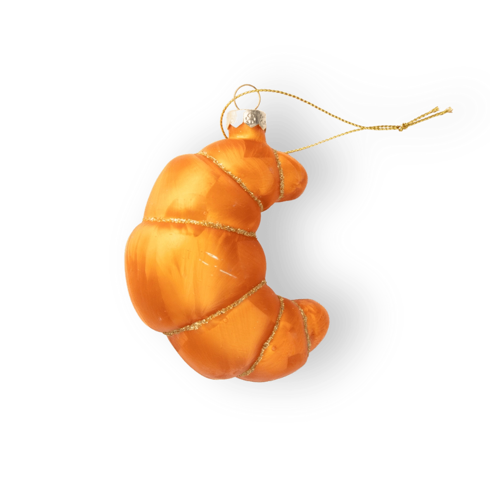 Chive glass croissant ornament in orange with a gilded thread hanger.