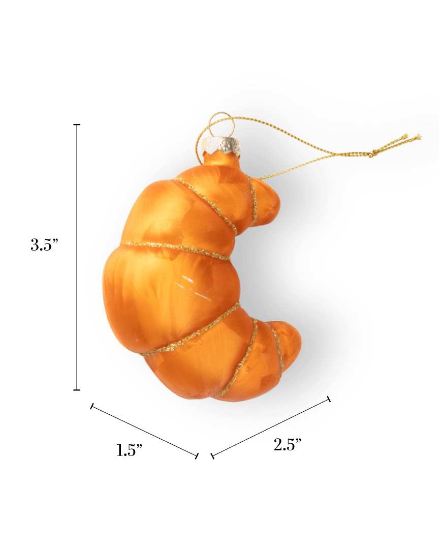 Chive glass croissant ornament in golden orange with a gold glitter spiral wrap.