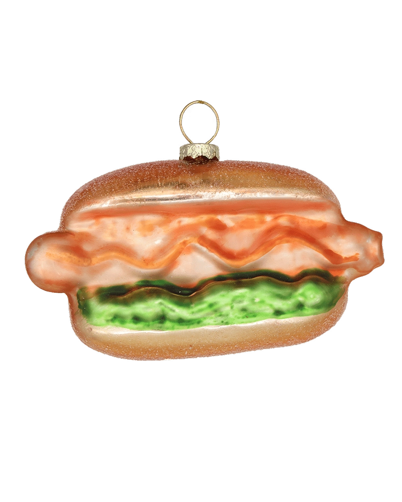 Chive glass hot dog ornament with ketchup and relish detail on a soft bun.