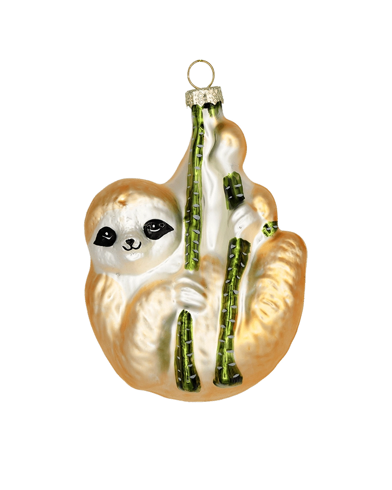 Chive glass sloth ornament in tan and cream, clinging to green branches.