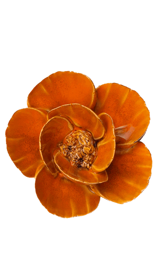 An orange ceramic flower-shaped candle holder with layered petals and a textured brown center, isolated on a white background.